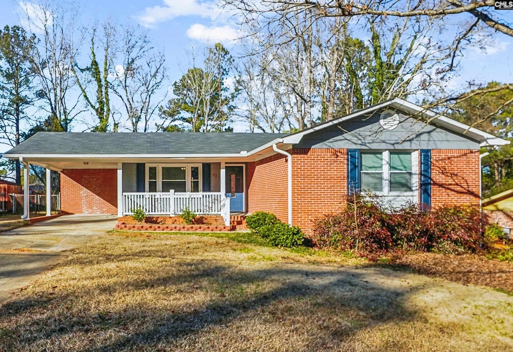 single story home featuring a front yard, a porch, and a carport