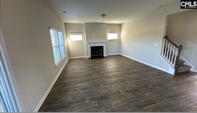 unfurnished living room featuring dark hardwood / wood-style floors