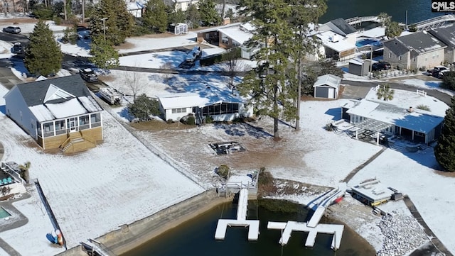 snowy aerial view featuring a water view