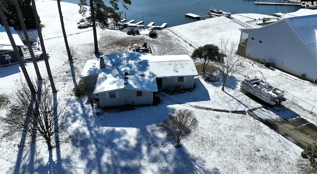 snowy aerial view with a water view