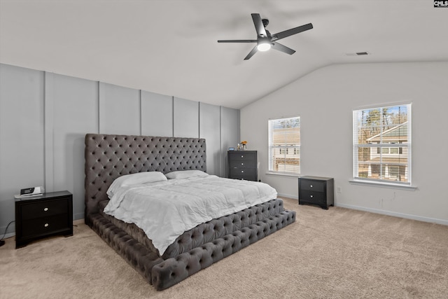 bedroom featuring ceiling fan, light colored carpet, and lofted ceiling