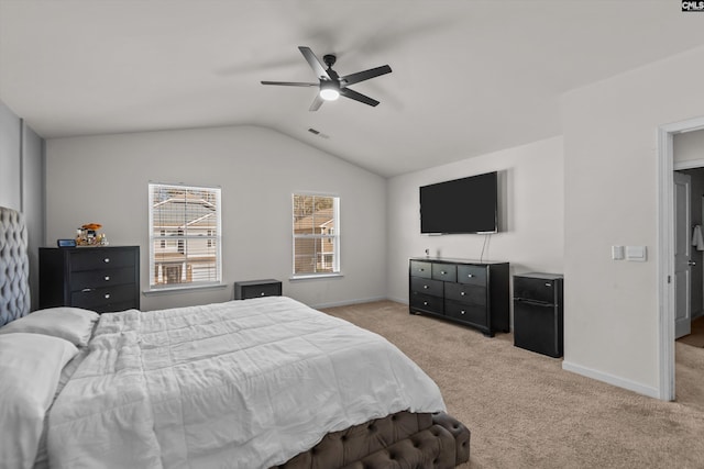 carpeted bedroom with black fridge, ceiling fan, and lofted ceiling