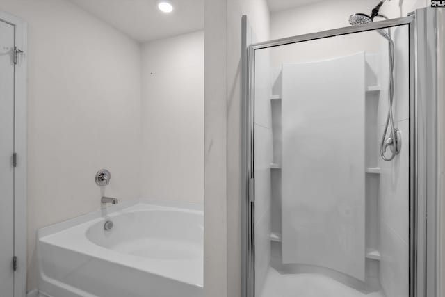 bathroom featuring separate shower and tub