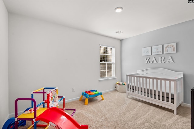 bedroom with carpet and a crib