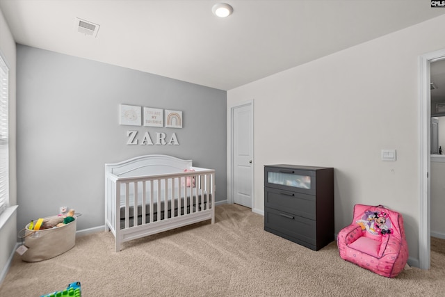 carpeted bedroom with a crib