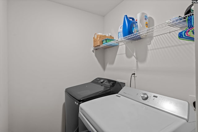 clothes washing area with independent washer and dryer