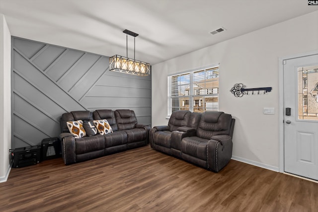 living room with a chandelier and hardwood / wood-style floors