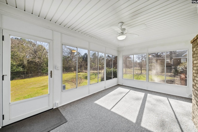 unfurnished sunroom with ceiling fan and plenty of natural light