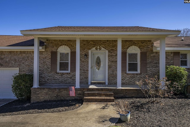 view of front of property with a garage and a porch