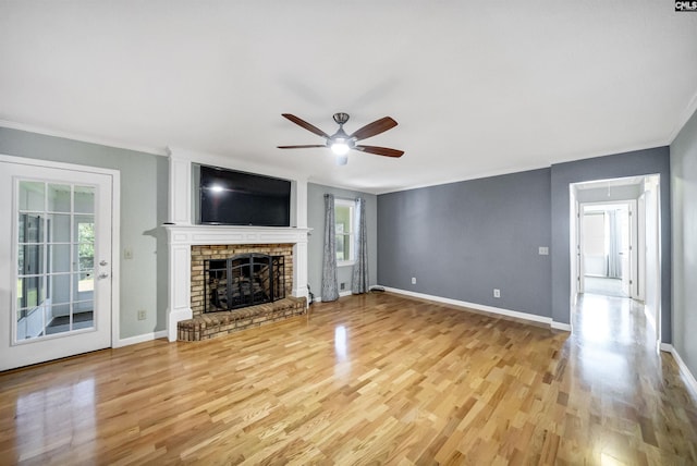 unfurnished living room featuring ceiling fan, a fireplace, and light hardwood / wood-style flooring