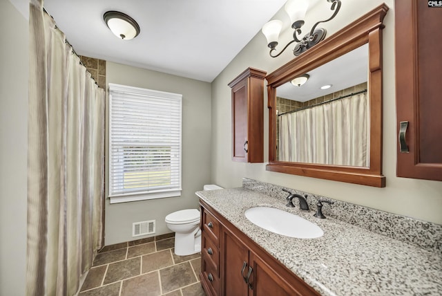 bathroom featuring toilet and vanity