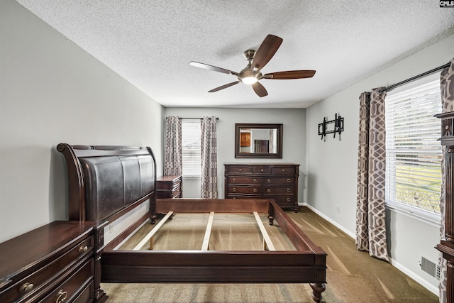 carpeted bedroom featuring a textured ceiling and ceiling fan