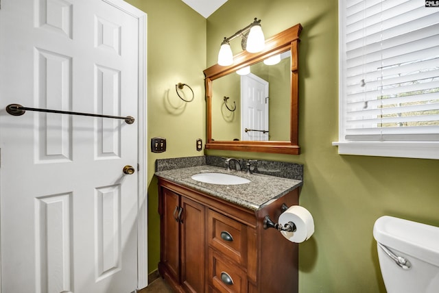 bathroom featuring toilet and vanity