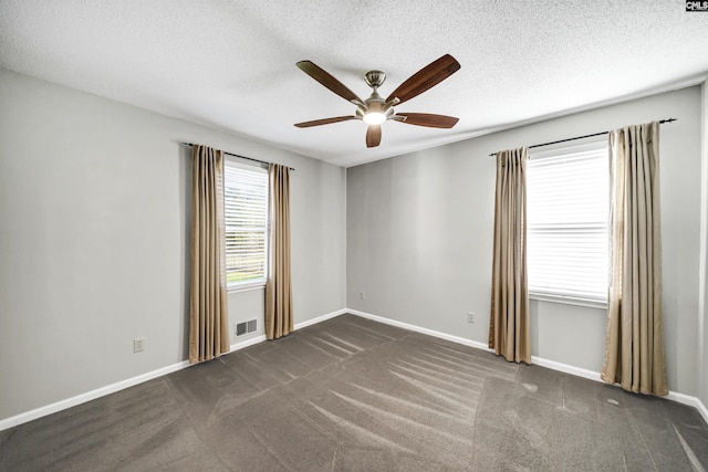 carpeted empty room featuring a textured ceiling and ceiling fan