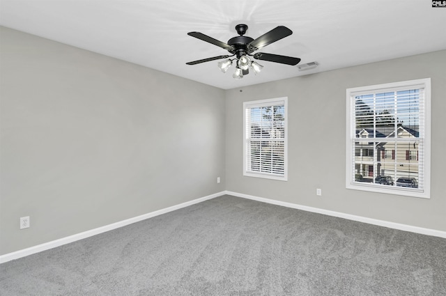 carpeted empty room featuring ceiling fan