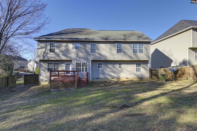 back of house with a wooden deck and a lawn