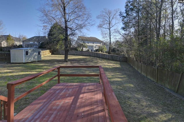 view of yard featuring a wooden deck and a storage unit