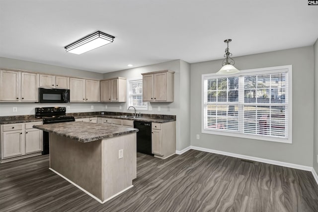 kitchen featuring hanging light fixtures, black appliances, a wealth of natural light, and a kitchen island