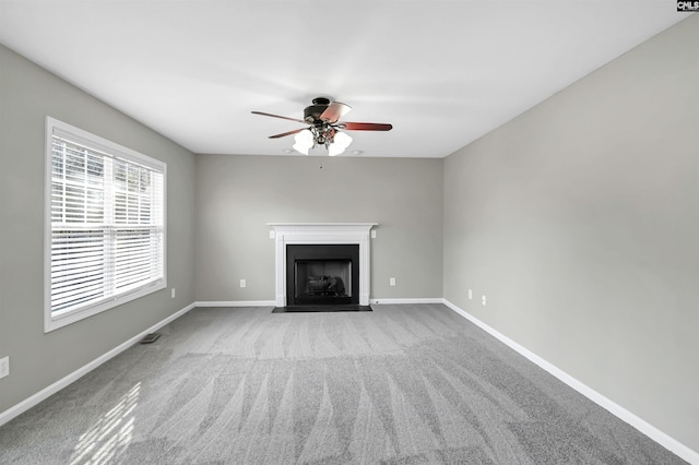 unfurnished living room with ceiling fan and light colored carpet