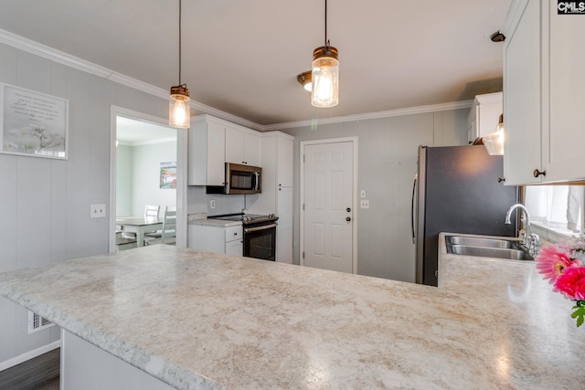 kitchen with decorative light fixtures, kitchen peninsula, white cabinets, and stainless steel appliances