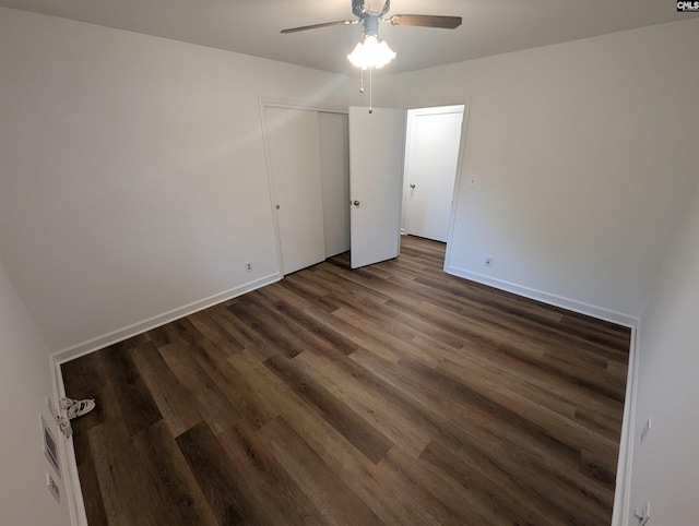 empty room with dark hardwood / wood-style floors and ceiling fan