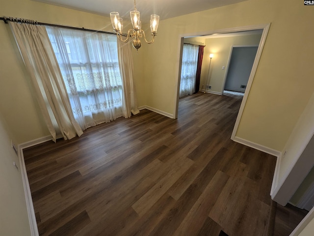 unfurnished dining area with a notable chandelier and dark hardwood / wood-style floors