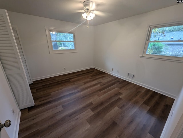 unfurnished bedroom with a closet, dark hardwood / wood-style floors, and ceiling fan