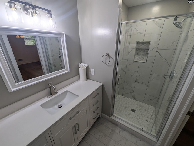 bathroom featuring vanity and an enclosed shower