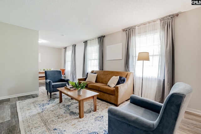 living room with hardwood / wood-style flooring and a textured ceiling