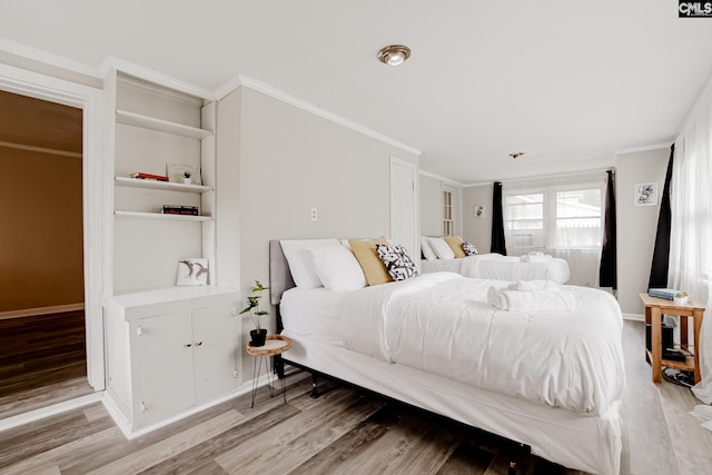 bedroom with crown molding and light hardwood / wood-style flooring