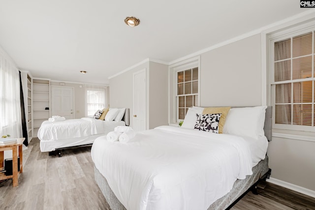 bedroom featuring crown molding and hardwood / wood-style floors