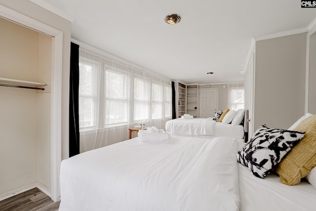 bedroom with crown molding and wood-type flooring