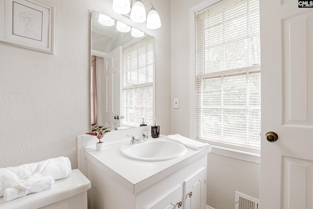 bathroom featuring toilet and vanity