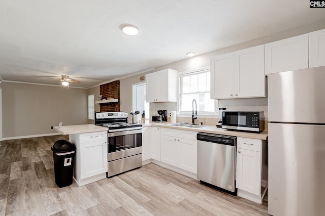 kitchen featuring kitchen peninsula, white cabinets, and stainless steel appliances