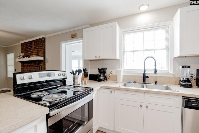 kitchen featuring sink, crown molding, white cabinetry, and stainless steel appliances