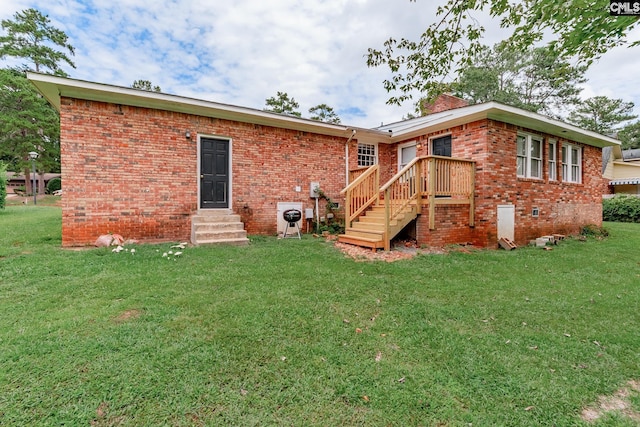 rear view of property with a yard