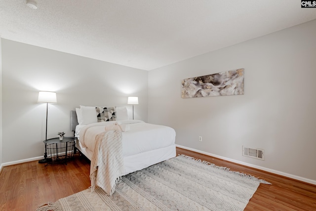 bedroom featuring wood-type flooring