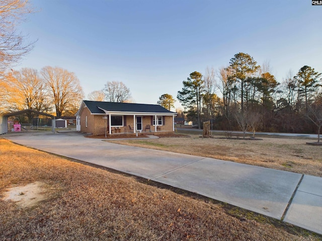 ranch-style house with a front yard and a carport