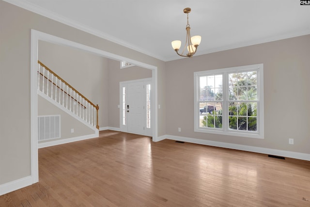 foyer featuring an inviting chandelier and light hardwood / wood-style flooring