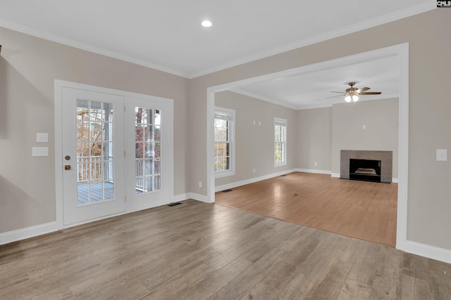 unfurnished living room with ceiling fan, light hardwood / wood-style flooring, and crown molding