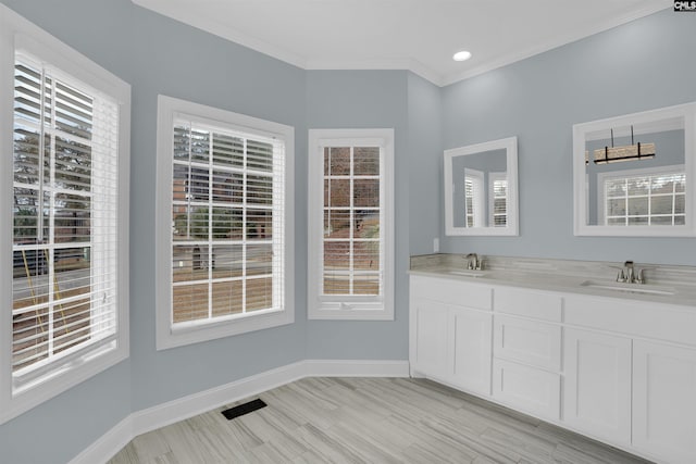 bathroom with vanity and ornamental molding