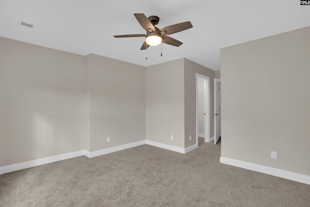 carpeted spare room featuring ceiling fan