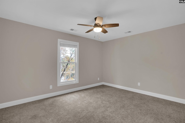 empty room with ceiling fan and carpet flooring