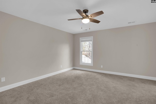 empty room with ceiling fan and carpet