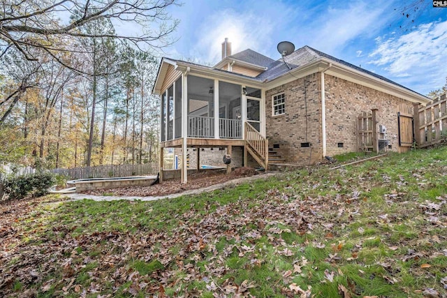 rear view of property with a sunroom