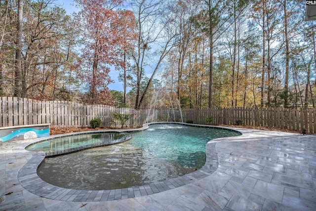 view of swimming pool with a patio