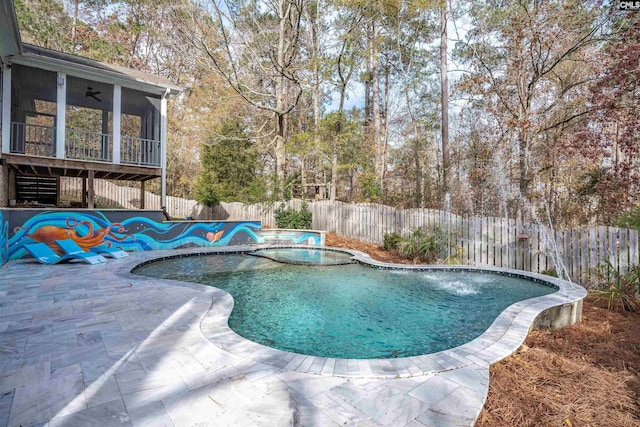 view of pool featuring an in ground hot tub, a patio area, and a sunroom