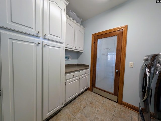 washroom with cabinets and washer and dryer