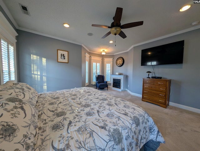 bedroom with ceiling fan, multiple windows, light carpet, and ornamental molding