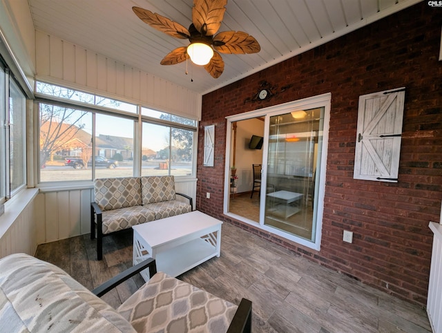 sunroom featuring ceiling fan and plenty of natural light